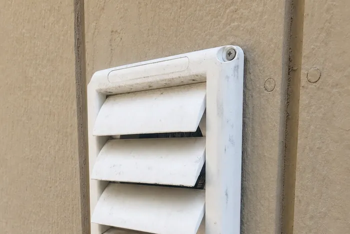 The white louvered hood cap Steve installs, photographed on a job — his own photo